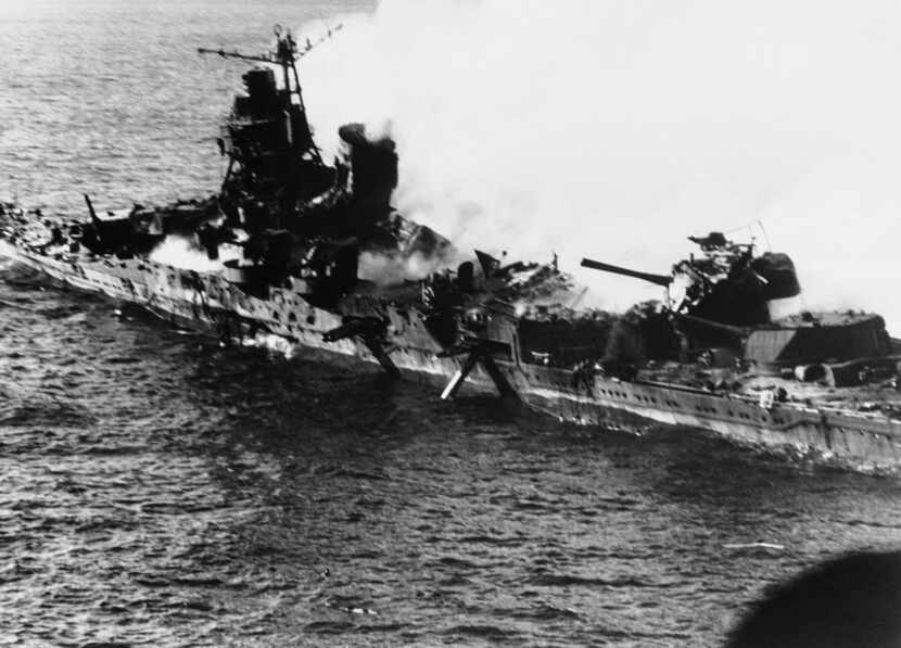 A Mogami-class Japanese cruiser is the flaming target of carrier-based U.S. naval aircraft...