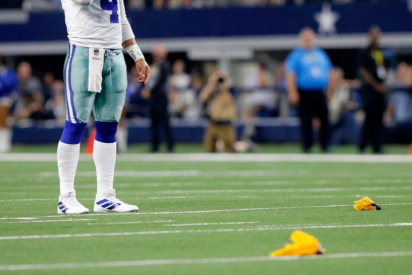 Dallas Cowboys quarterback Dak Prescott (4) waits for officials to sort out a penalty flag...