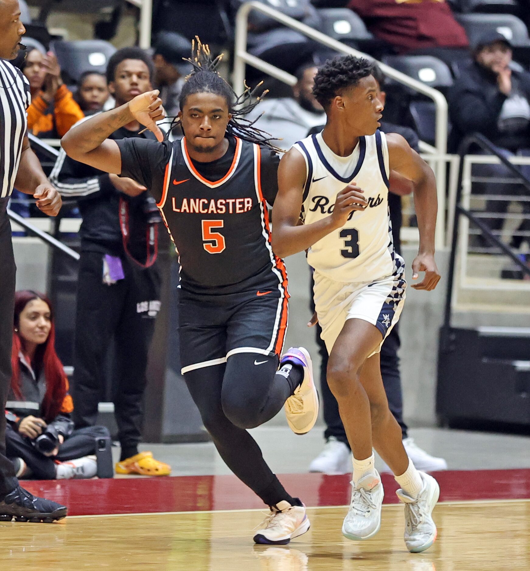 Lancaster's Mario Perry (5) celebrates after dropping in a three-point-dagger during the...