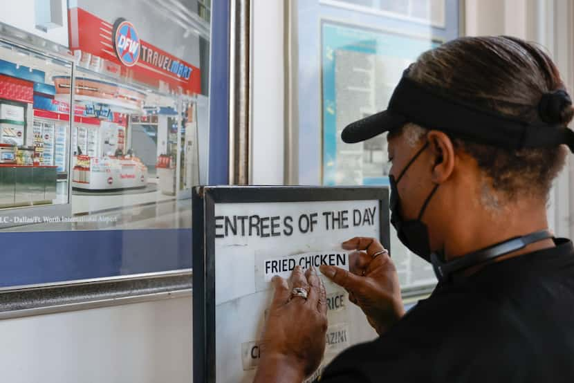 Two Podners Restaurant employee Meche White prepares the drive-through menu on, Thursday,...