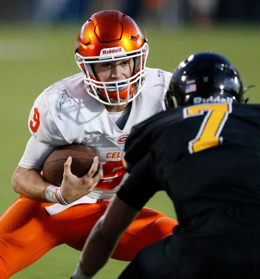 Celina High School quarterback Hunter Watson (9) tries to get past Memorial High School...