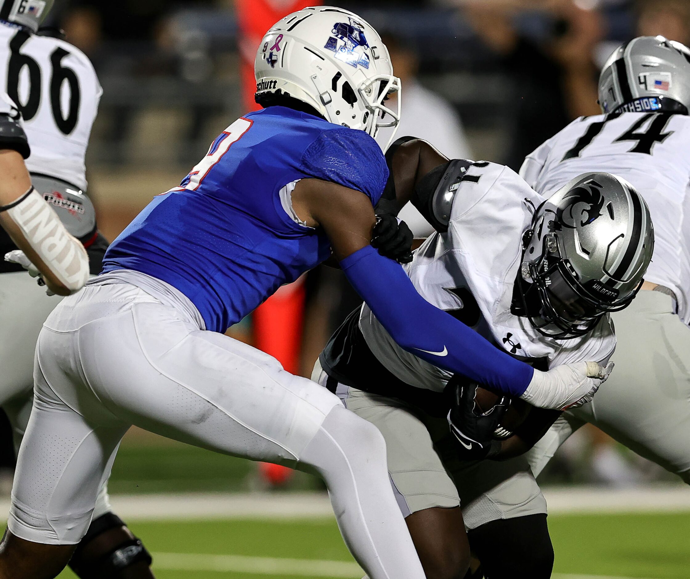 Allen defensive lineman Zina Umeozulu (left) makes a stop on Denton Guyer running back Ahmed...