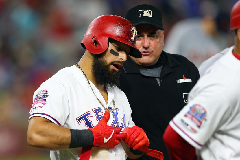 ARLINGTON, TX - AUGUST 03: Eric Cooper #56 umpire talks with Rougned Odor #12 of the Texas...