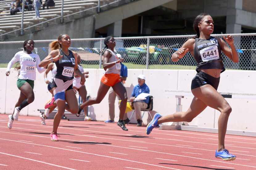North Crowley's Indya Mayberry (bib number 6441), right, sprints away from the competition...