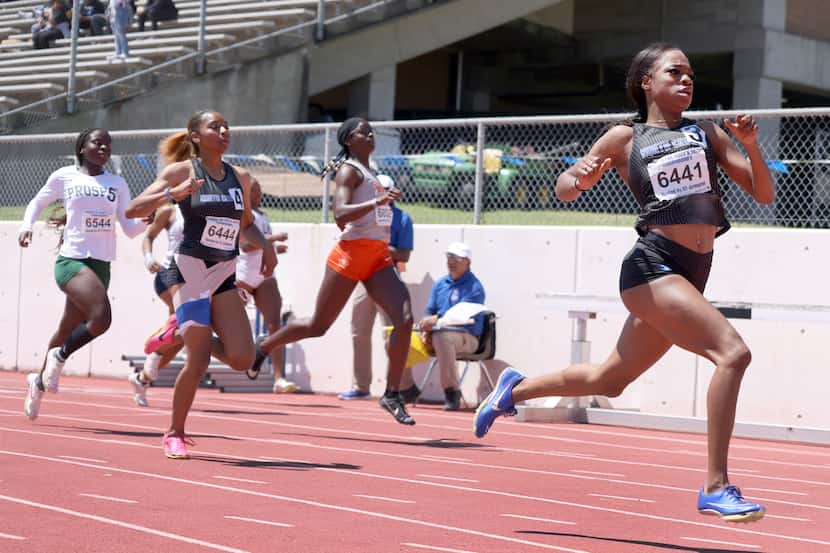 North Crowley's Indya Mayberry (bib number 6441), right, sprints away from the competition...