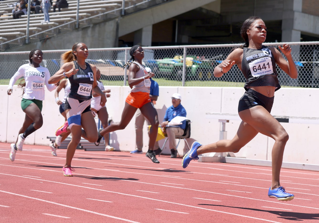 North Crowley's Indya Mayberry (bib number 6441), right, sprints away from the competition...