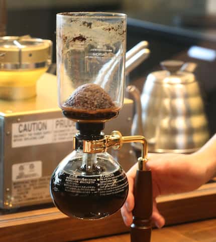 The siphoning process is one of Starbucks Reserve Bars' most complex. Here, the dome shape...
