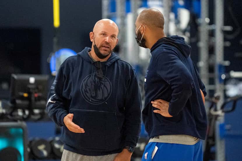 Dallas Mavericks head coach Jason Kidd confers with assistant coach Jared Dudley during the...