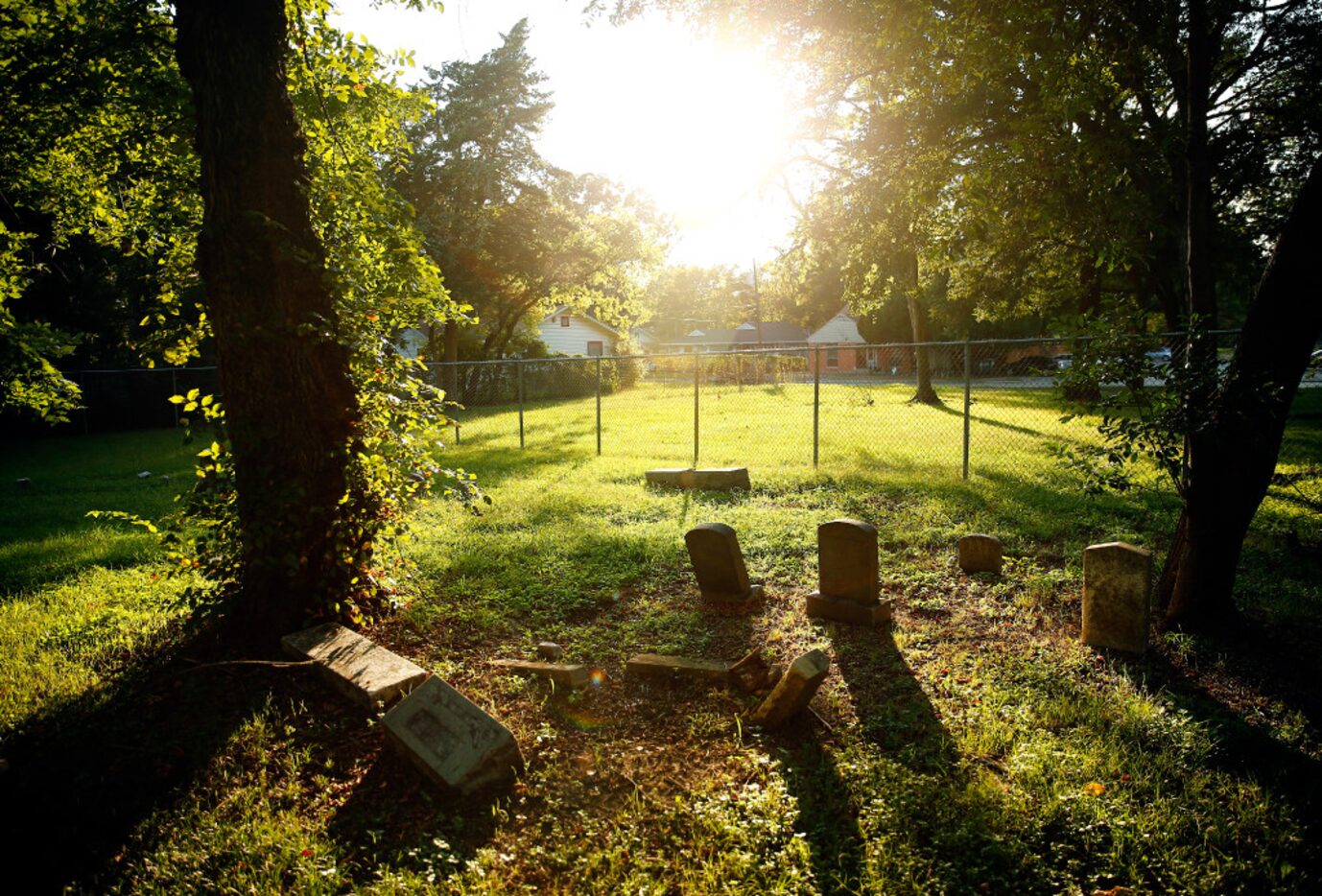 Gravestones in the Confederate Cemetery are seen as the sun sets in a South Dallas...