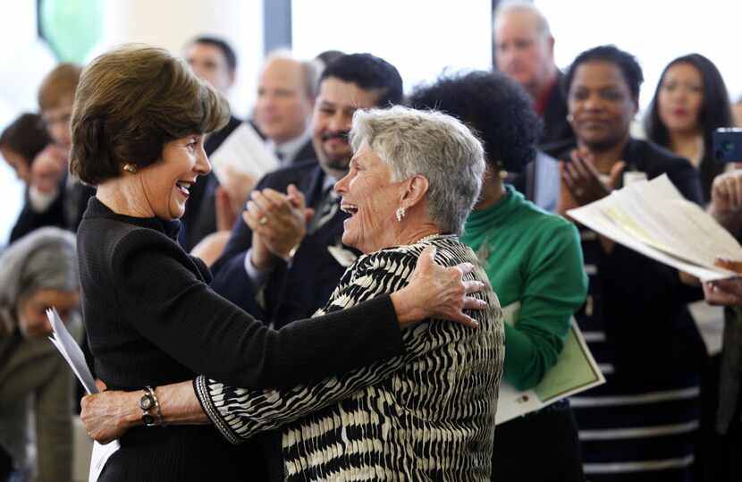 Former first lady Laura Bush hugs Dr. Harryette B. Ehrhardt, former Dallas ISD principal and...