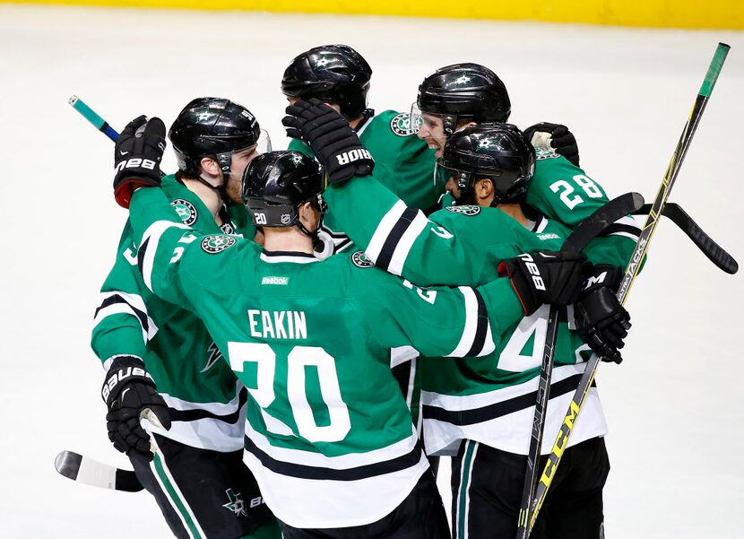 Dallas Stars defenseman Stephen Johns (28) is congratulated by teammates Cody Eakin (20),...