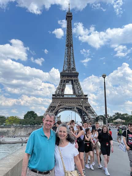 Author and her husband pose in front of the Eiffel Tower