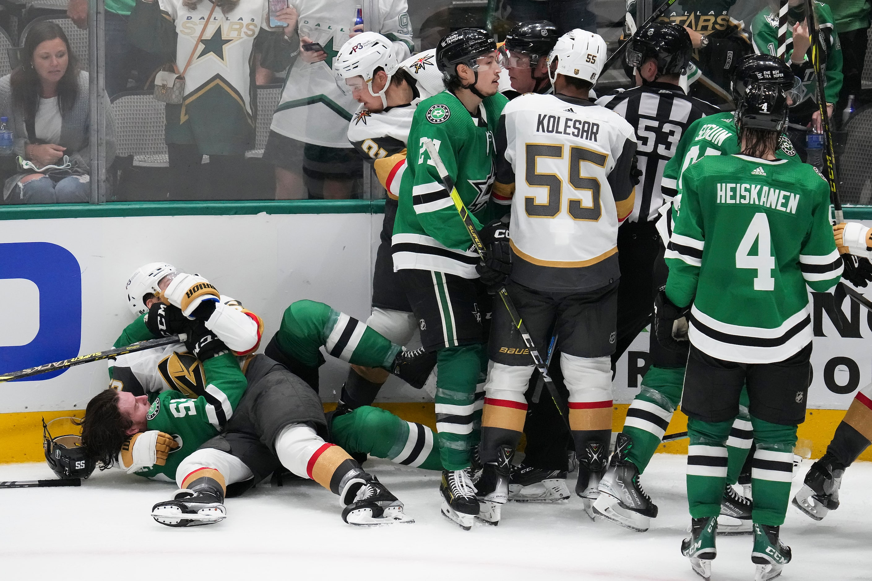 Players and officials try to separate Vegas Golden Knights defenseman Nicolas Hague (14)...