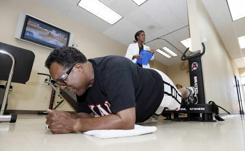 Dr. Donta Bennett monitored Caraway as he worked his core while in a plank position at NU...