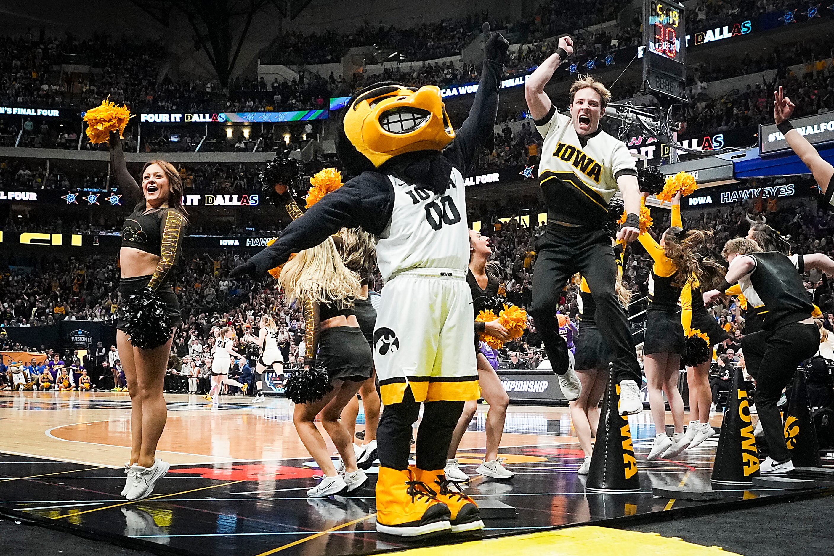 Iowa cheerleaders and mascot celebrate a three-pointer by guard Caitlin Clark during the...