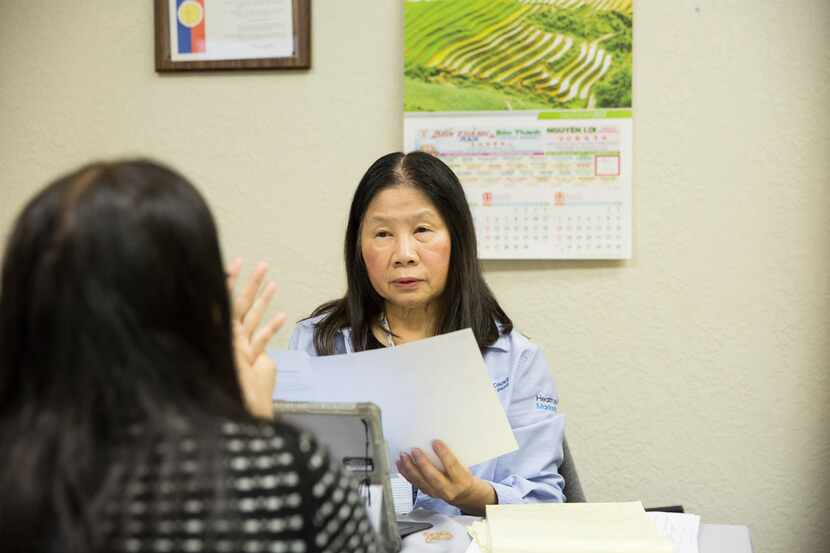 Lisa Pham (right), a Vietnamese-speaking health insurance marketplace navigator, speaks with...