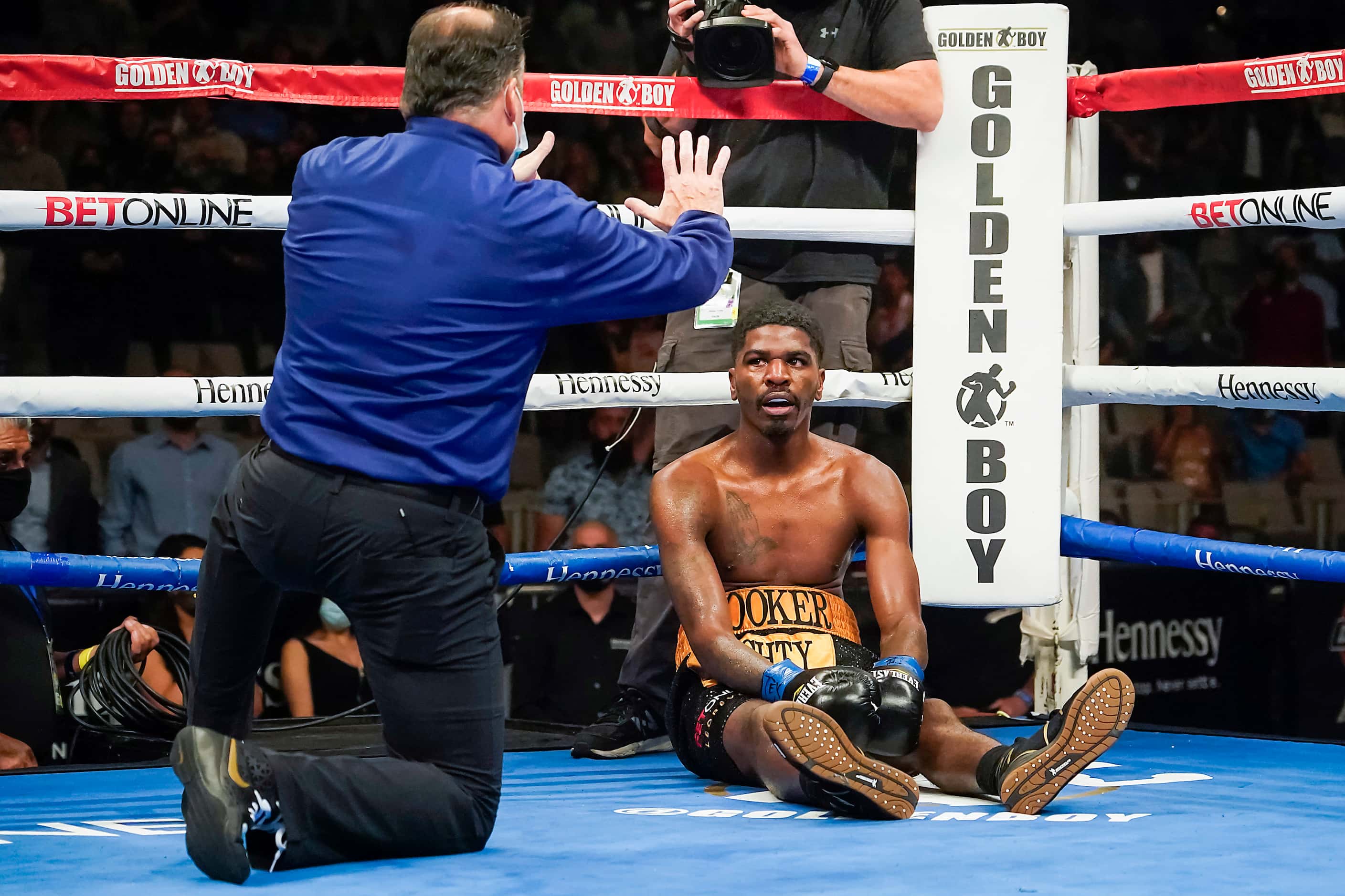Maurice Hooker waits out an eight count from for referee Laurence Cole after being knocked...