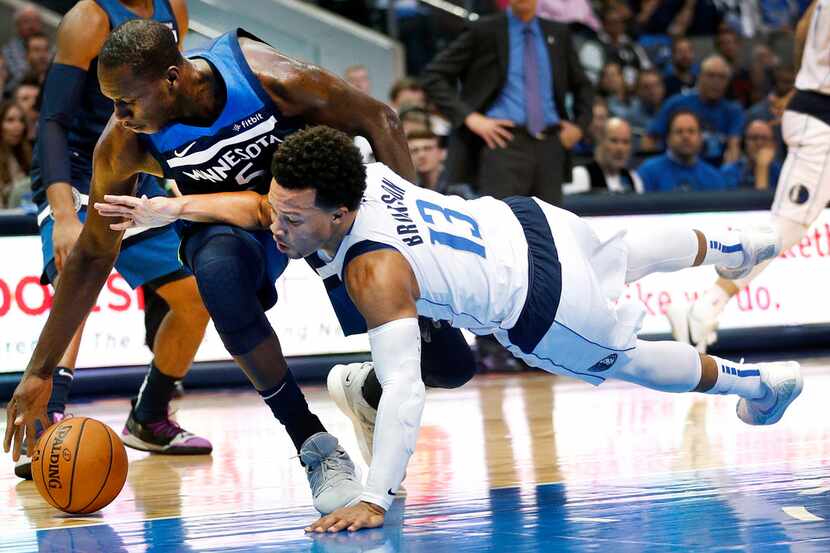 Dallas Mavericks guard Jalen Brunson (13) dives for the loose ball against Minnesota...