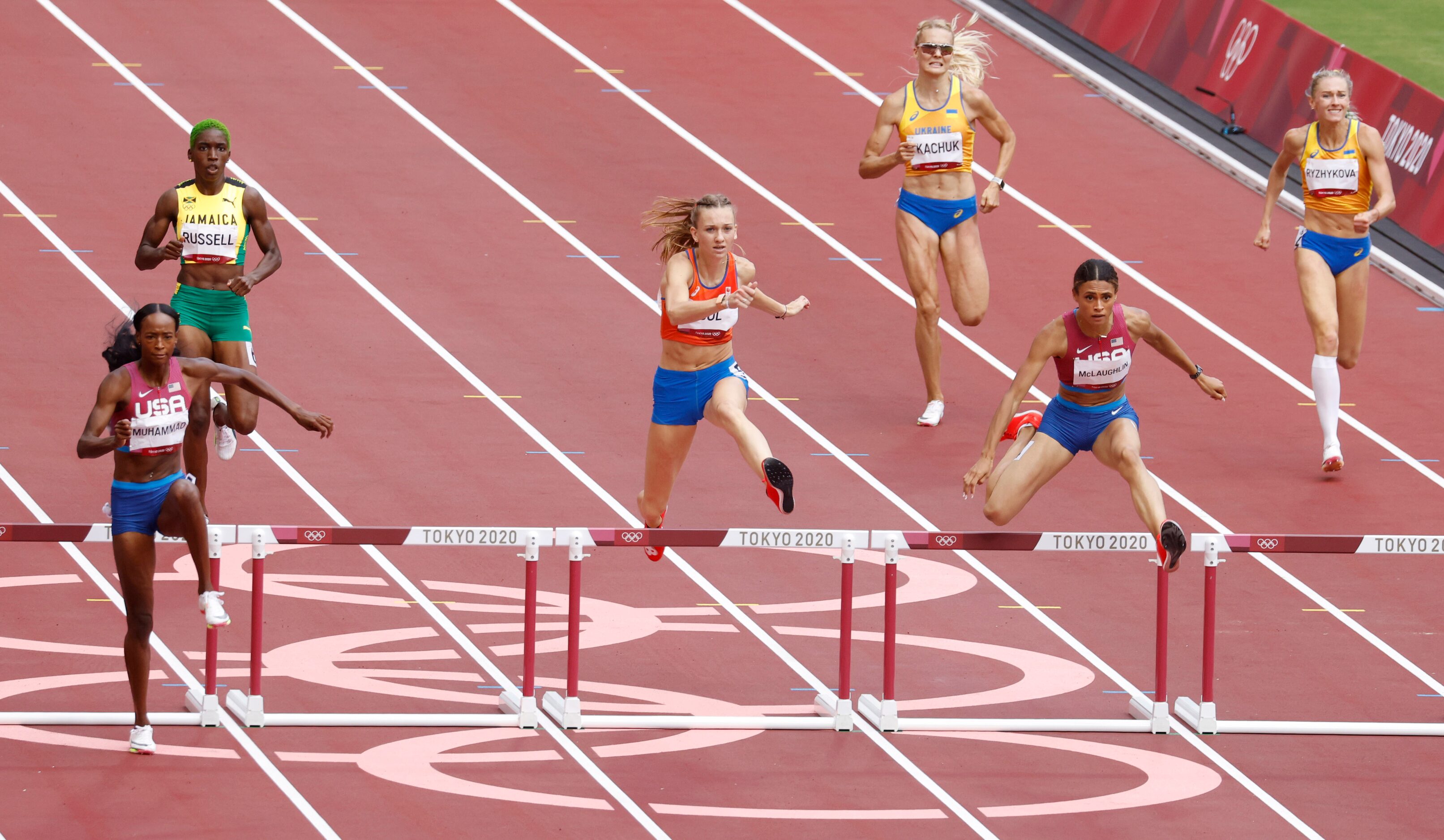 USA’s Dalilah Muhammad, Netherland’s Femke Bol, and USA’s Sydney McLaughlin clear the last...