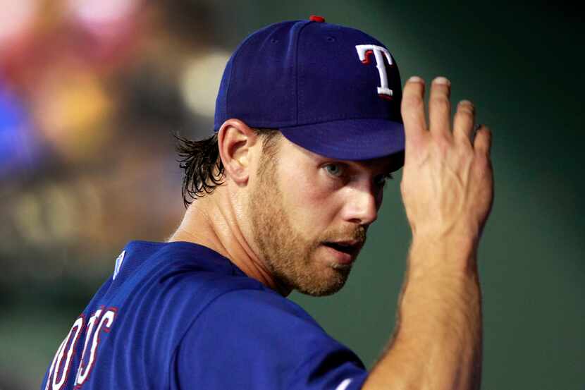Texas Rangers relief pitcher Neal Cotts (56) tips his hat to pitching coach Mike Maddux (not...