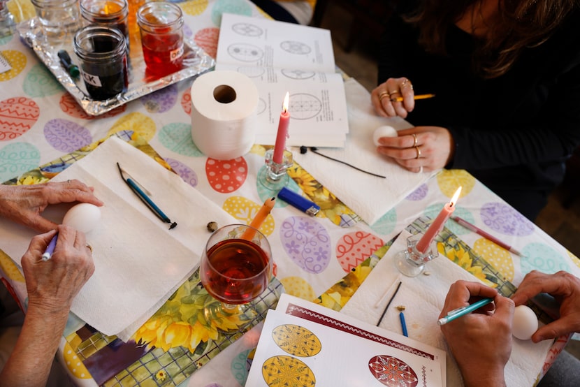 People draw Ukrainian designs on eggs, Saturday, April, 2, 2022 in Little Elm, Texas....