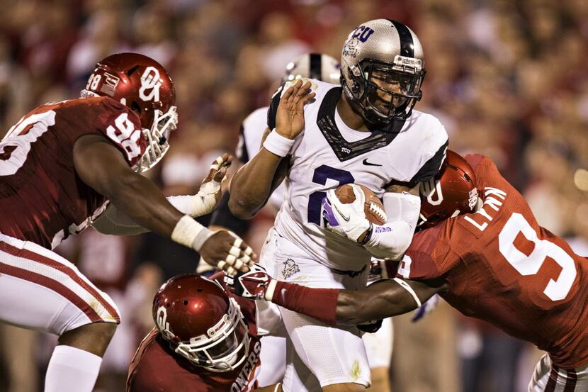 NORMAN, OK - OCTOBER 5:  Trevone Boykin #2 of the TCU Horned Frogs is tackled by Gabe Lynn...