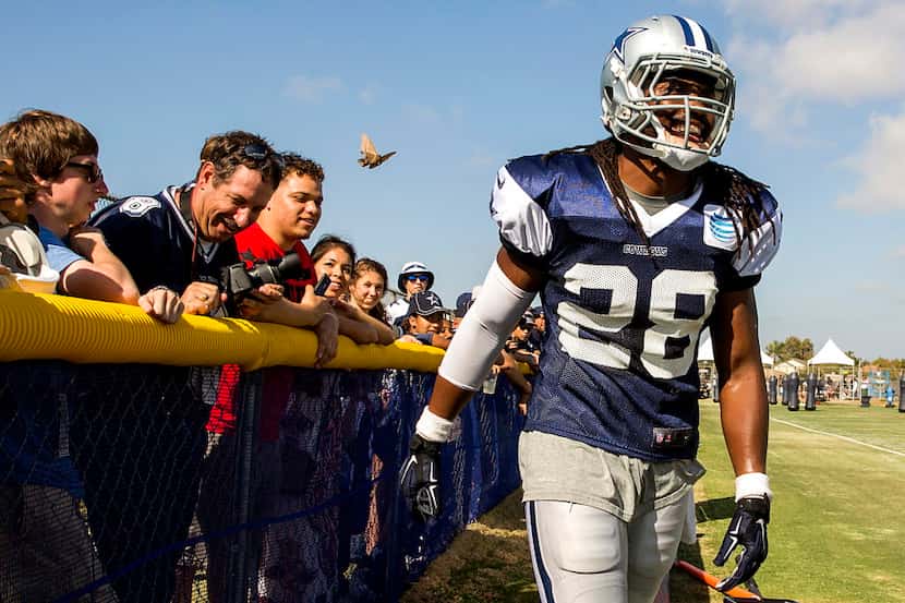 Dallas Cowboys defensive back Robert Steeples laughs with fans after a play that took him...