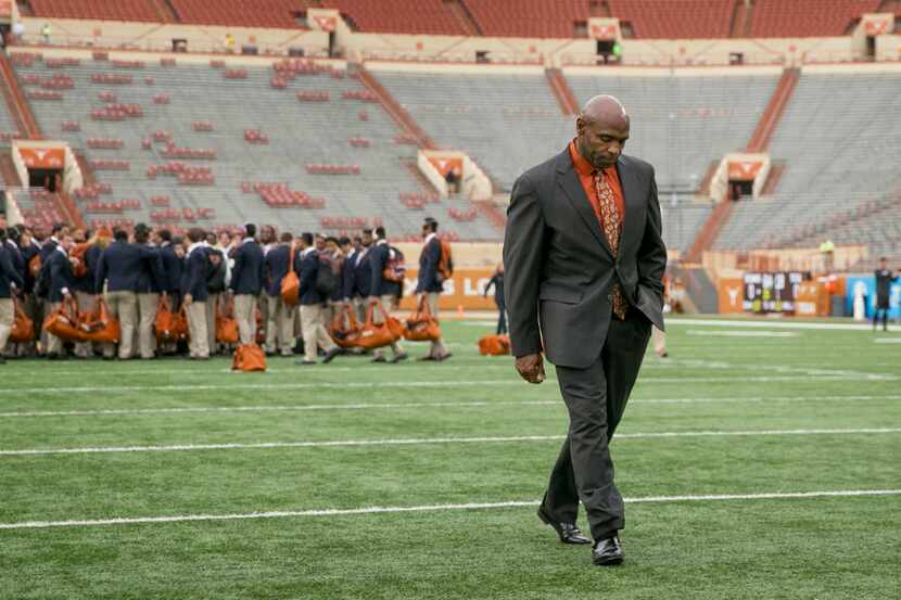 In this Friday, Nov. 25, 2016 photo, Texas coach Charlie Strong walks across the field at...