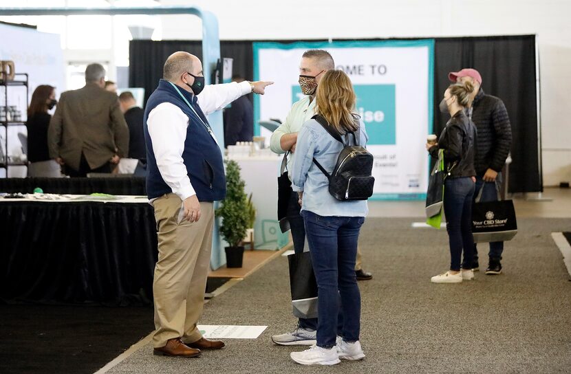 Patrons visit the different booths at The Franchise Show, a conference for local...