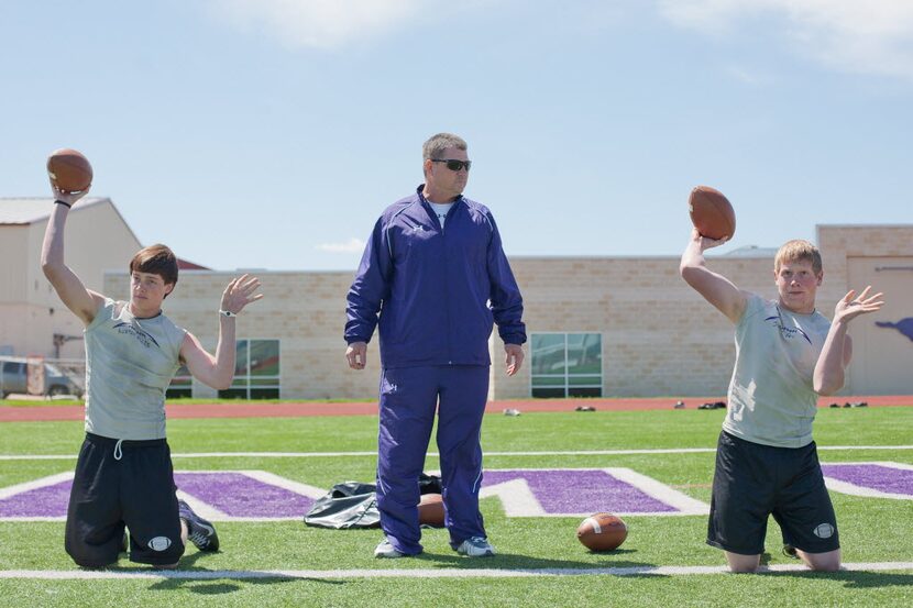 Coach Todd Dodge works out with his quarterbacks at Marble Falls High School on March 21,...