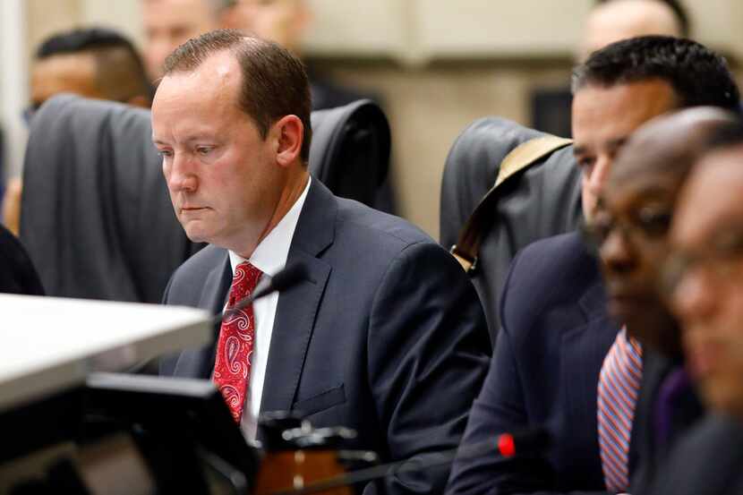 Dallas City Council member Philip Kingston looks at his computer as other members listen to...