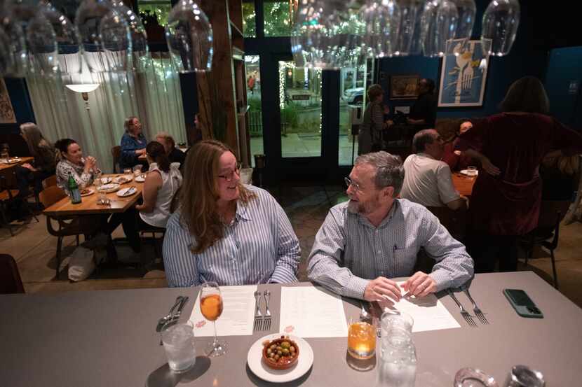 Patrons Carole Walter and Dale Walter sit at the bar as they wait for their reservation for...