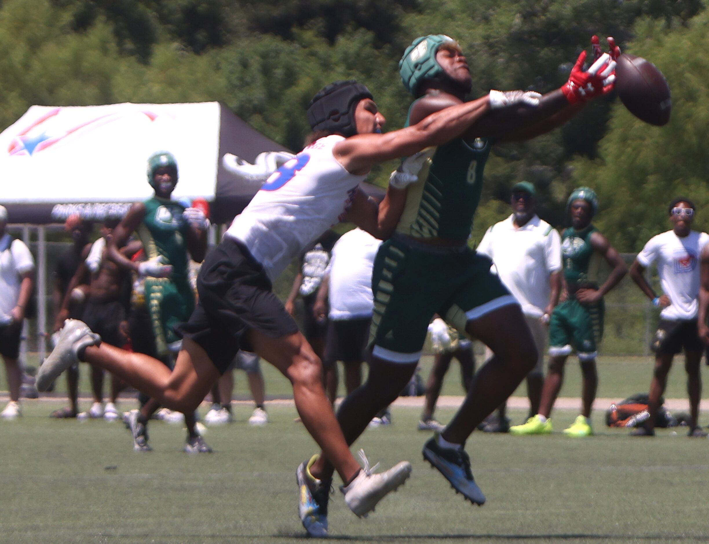 DeSoto receiver Jaden Trawick (8), right, reaches but is unable to pull in a long pass...