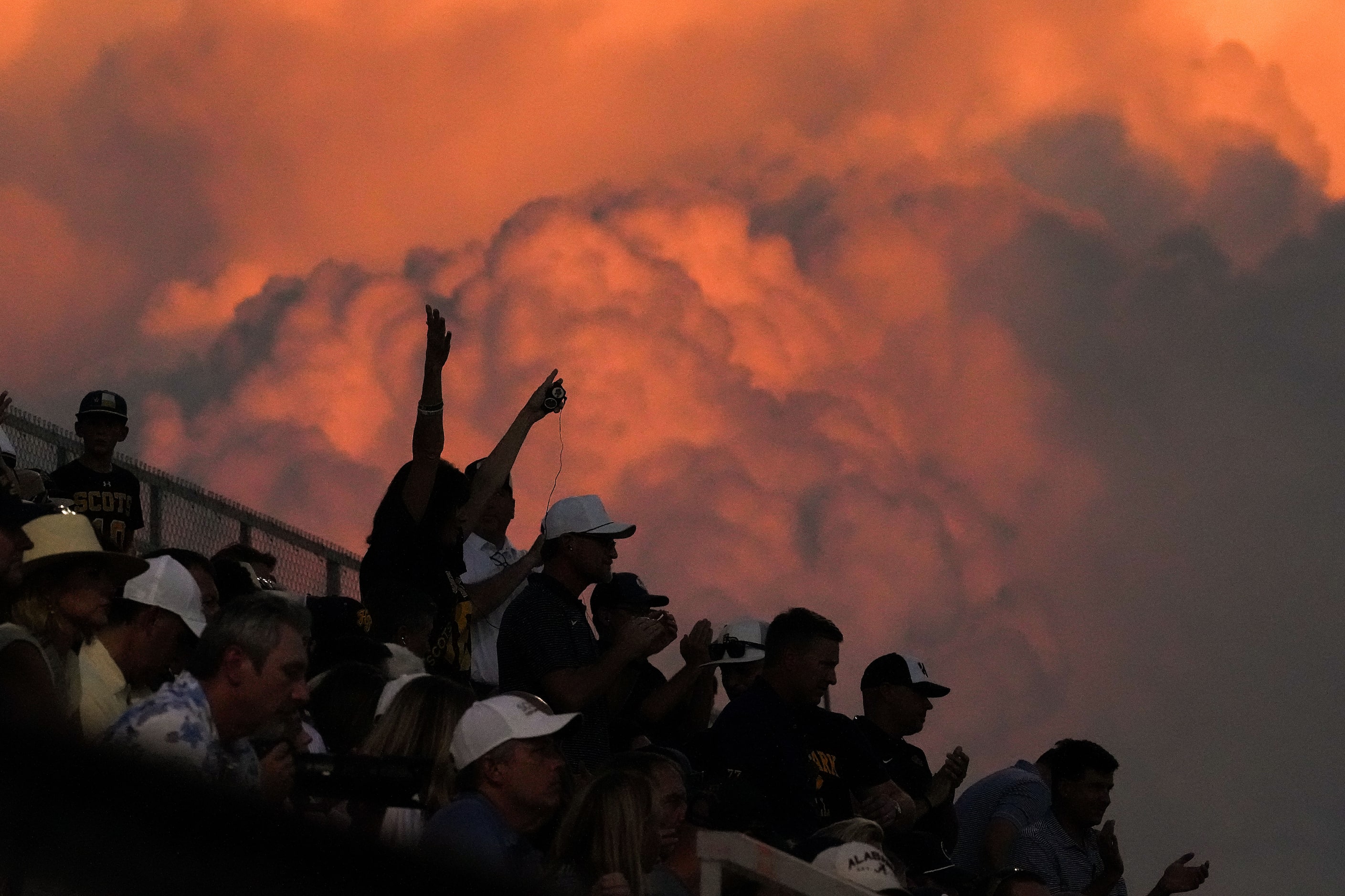 Highland Park fans cheer a Scots field goal during the first half of a high school football...