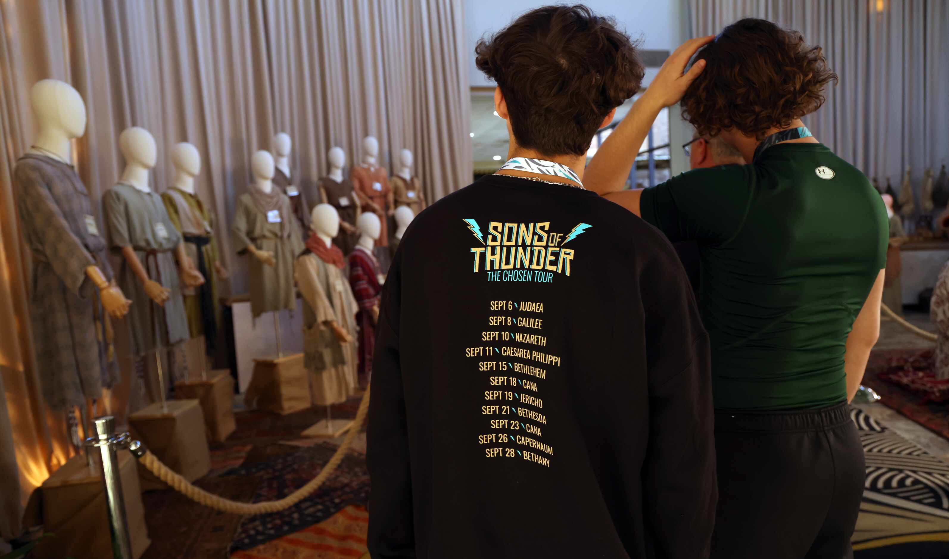 An attendee of ChosenCon sports a souvenir t-shirt listing all of the September stops along...