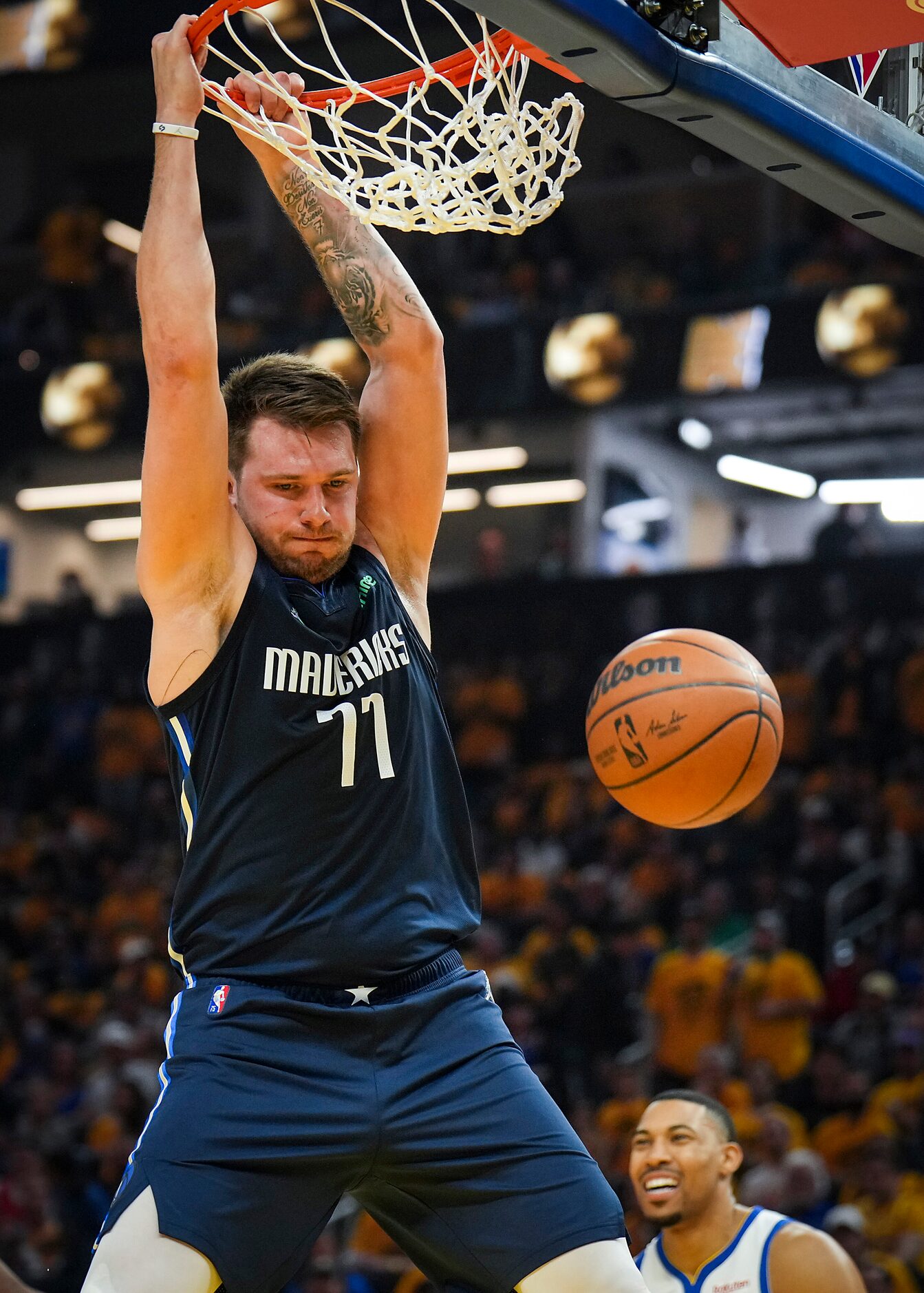 Dallas Mavericks guard Luka Doncic (77) dunks the ball past Golden State Warriors center...