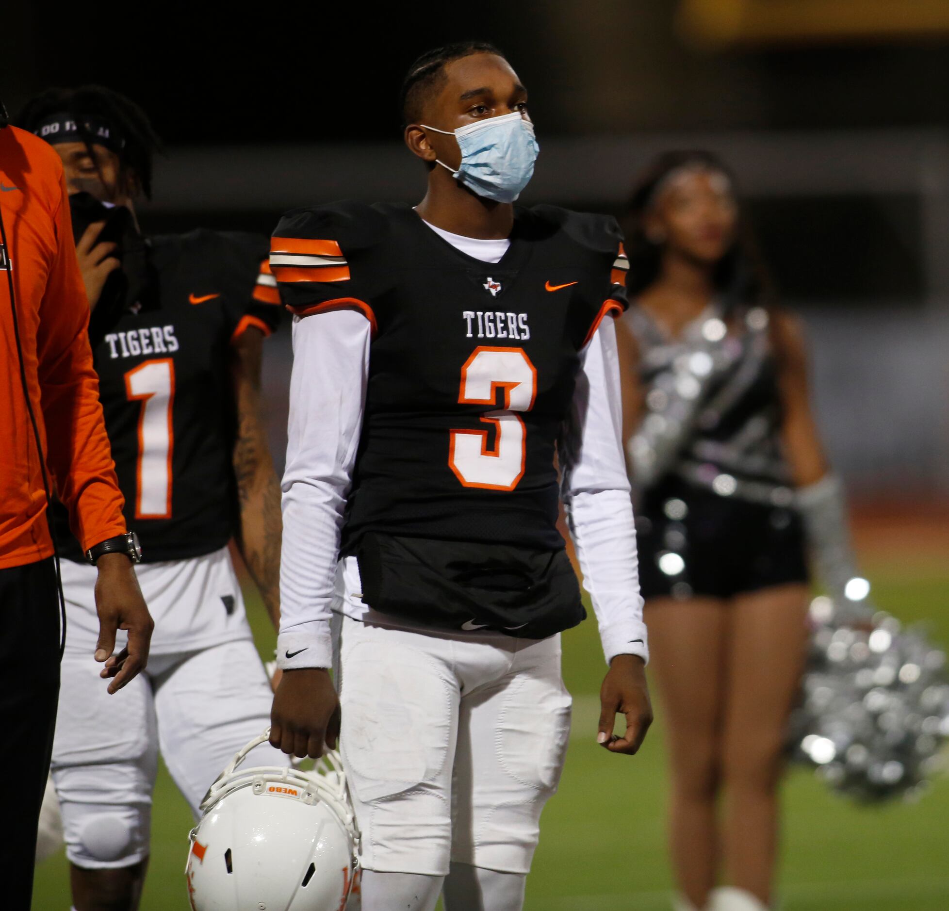 Lancaster quarterback Glenn Rice Jr. (3) pauses alongside other Tigers players during the...