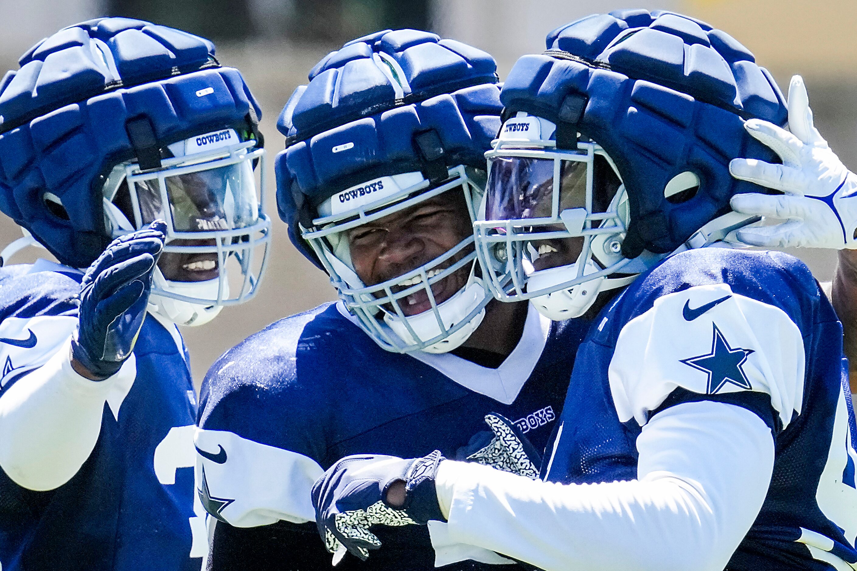 Dallas Cowboys defensive end Sam Williams (center) celebrates a defensive stop with...