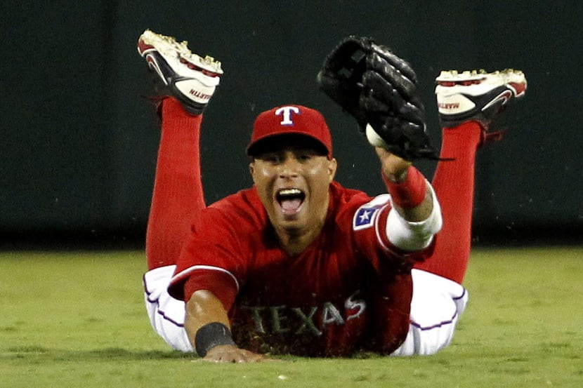Texas Rangers center fielder Leonys Martin dives for a fly ball hit by Tampa Bay Rays...