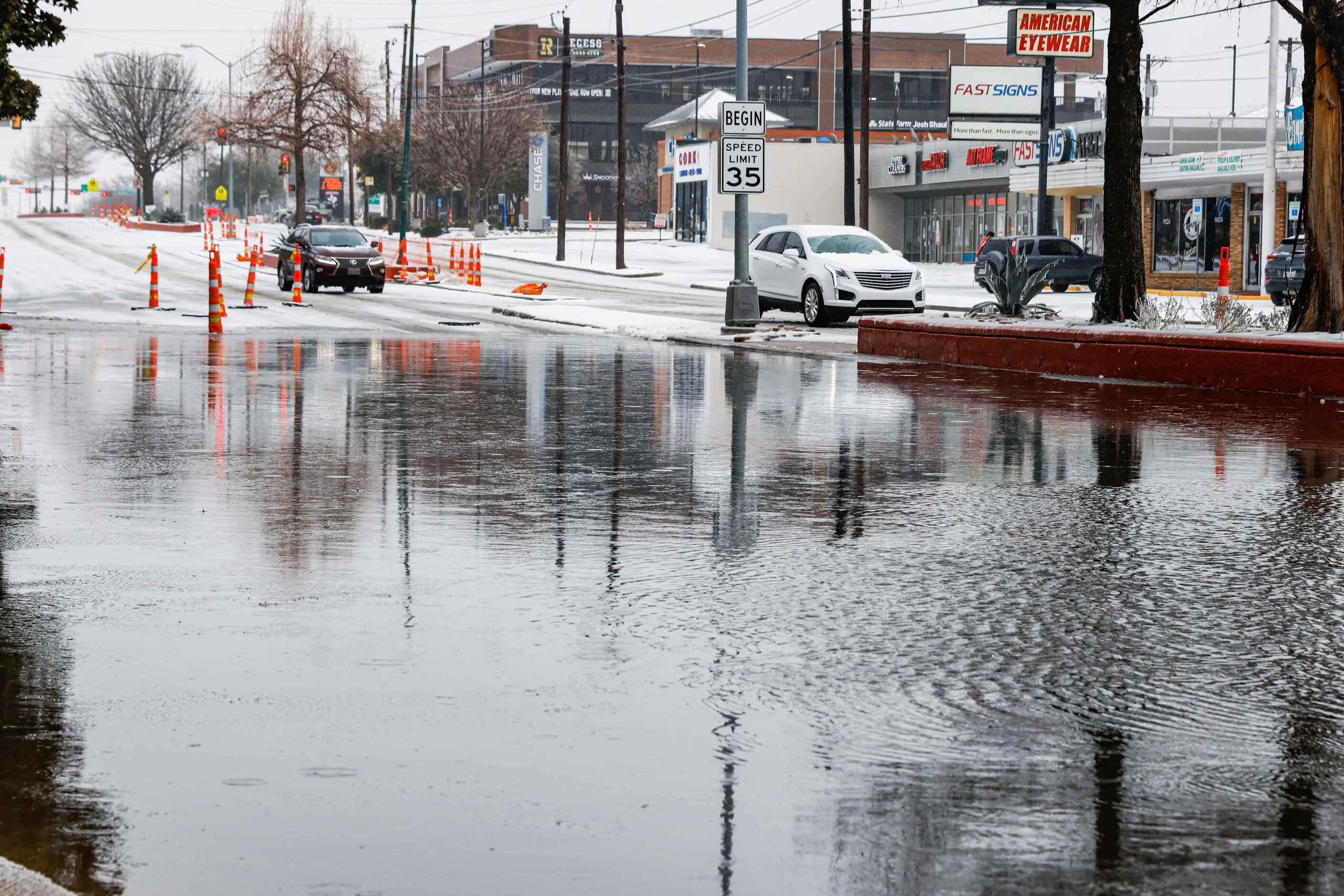 People drive on a snowy E Mockingbird Ln near N Central Expy where there is a severe build...