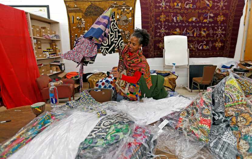 Owner Akwete Tyehimba sorts out dresses in February at Pan-African Connection in Dallas.