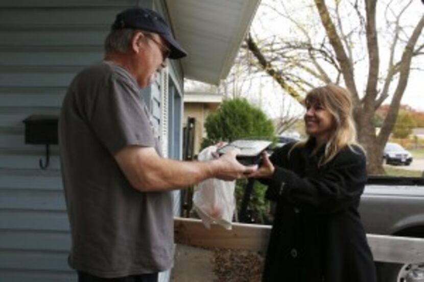  Volunteer Carmen Brito delivered a meal to John Lavender in Garland. (Rose Baca/The Dallas...