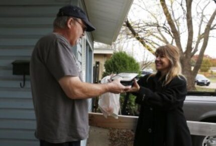  Volunteer Carmen Brito delivered a meal to John Lavender in Garland. (Rose Baca/The Dallas...