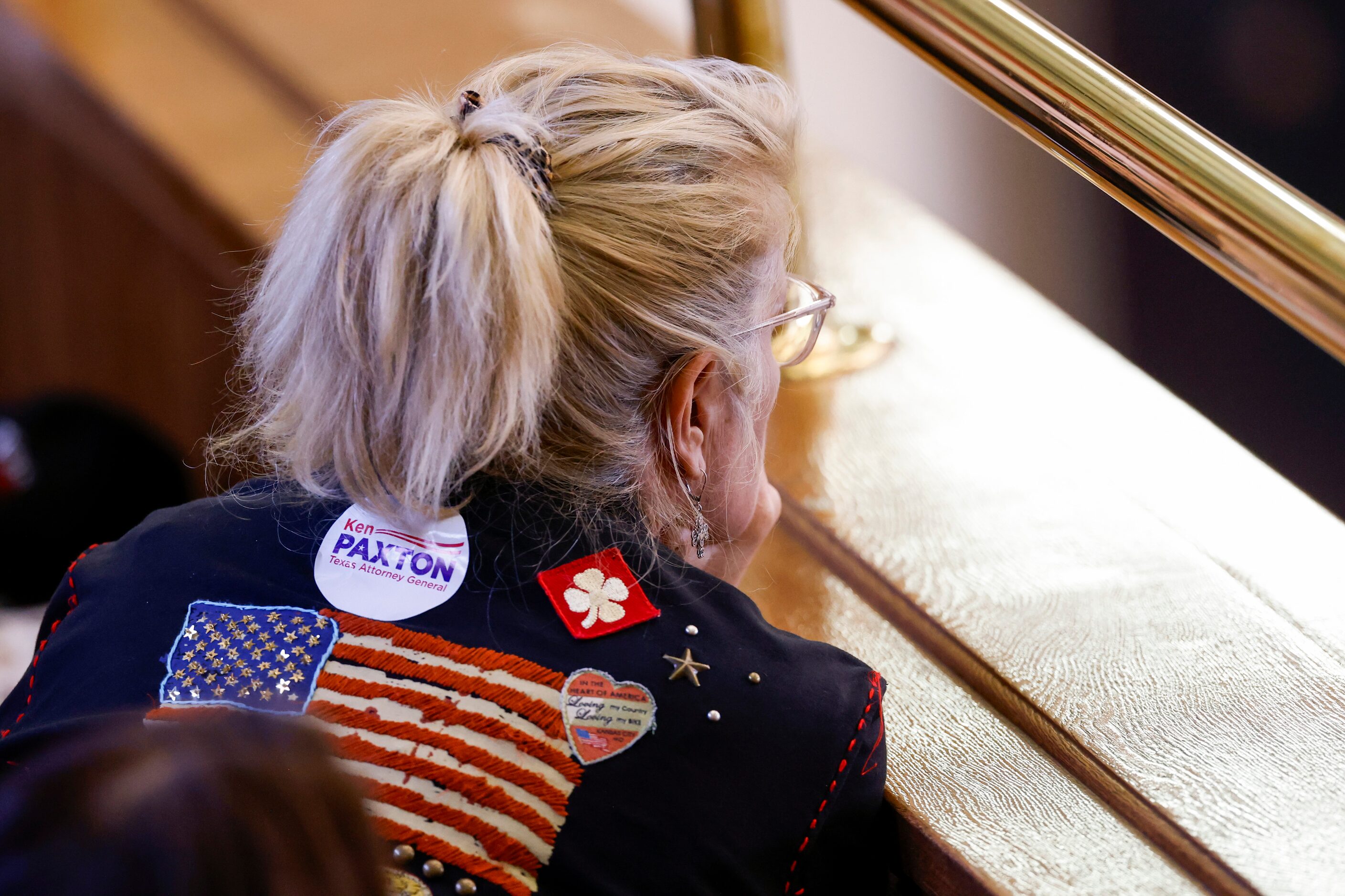 Marcia Watson, a Williamson County resident, leans over while listening to Dan Cogdell,...