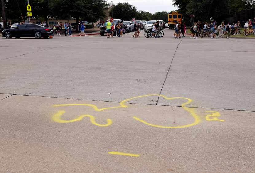 After the first day of school, spray painted markers indicate where Landon Bourque, 15, a...