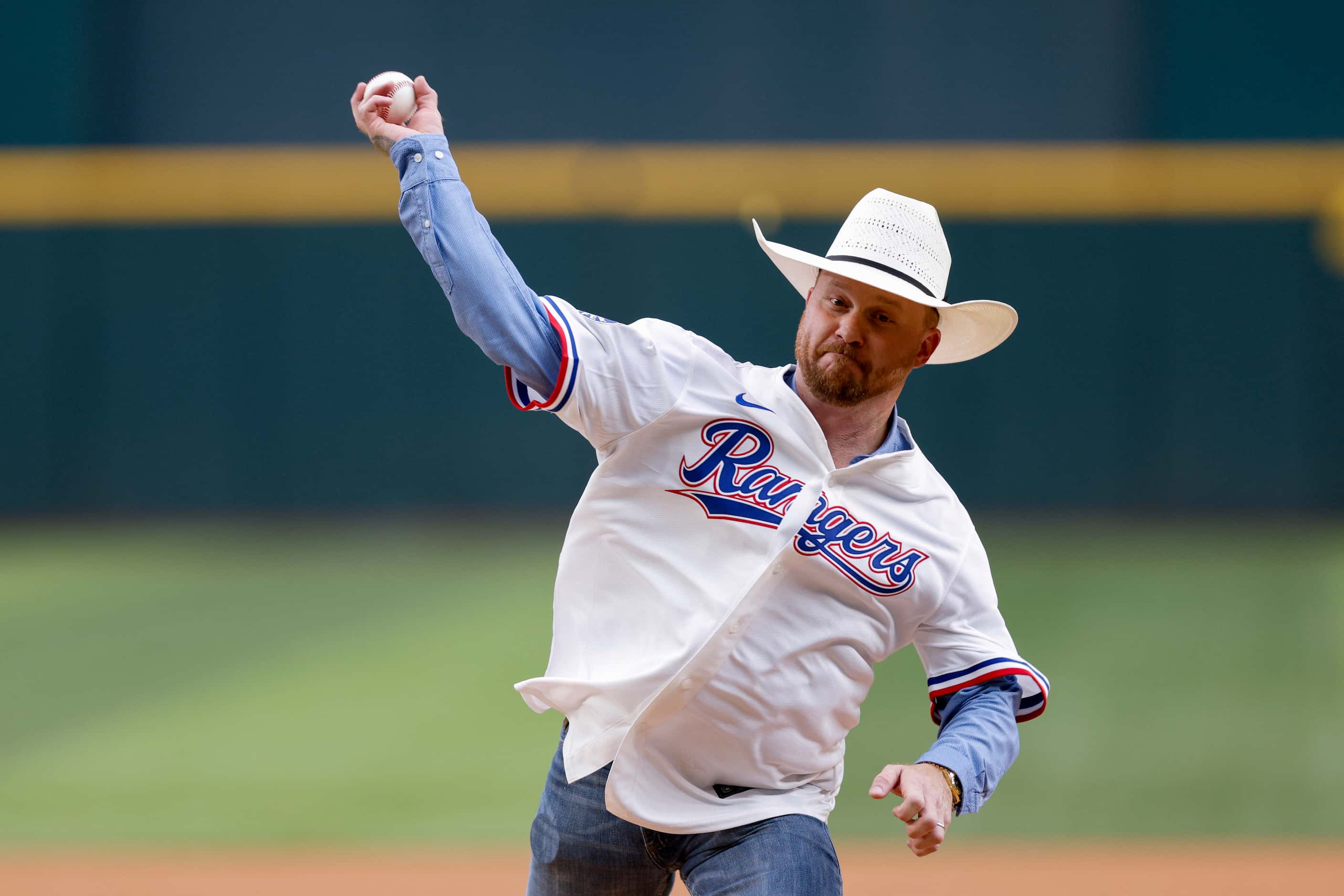 Country music singer Cody Johnson throws the ceremonial first pitch before an MLB game...