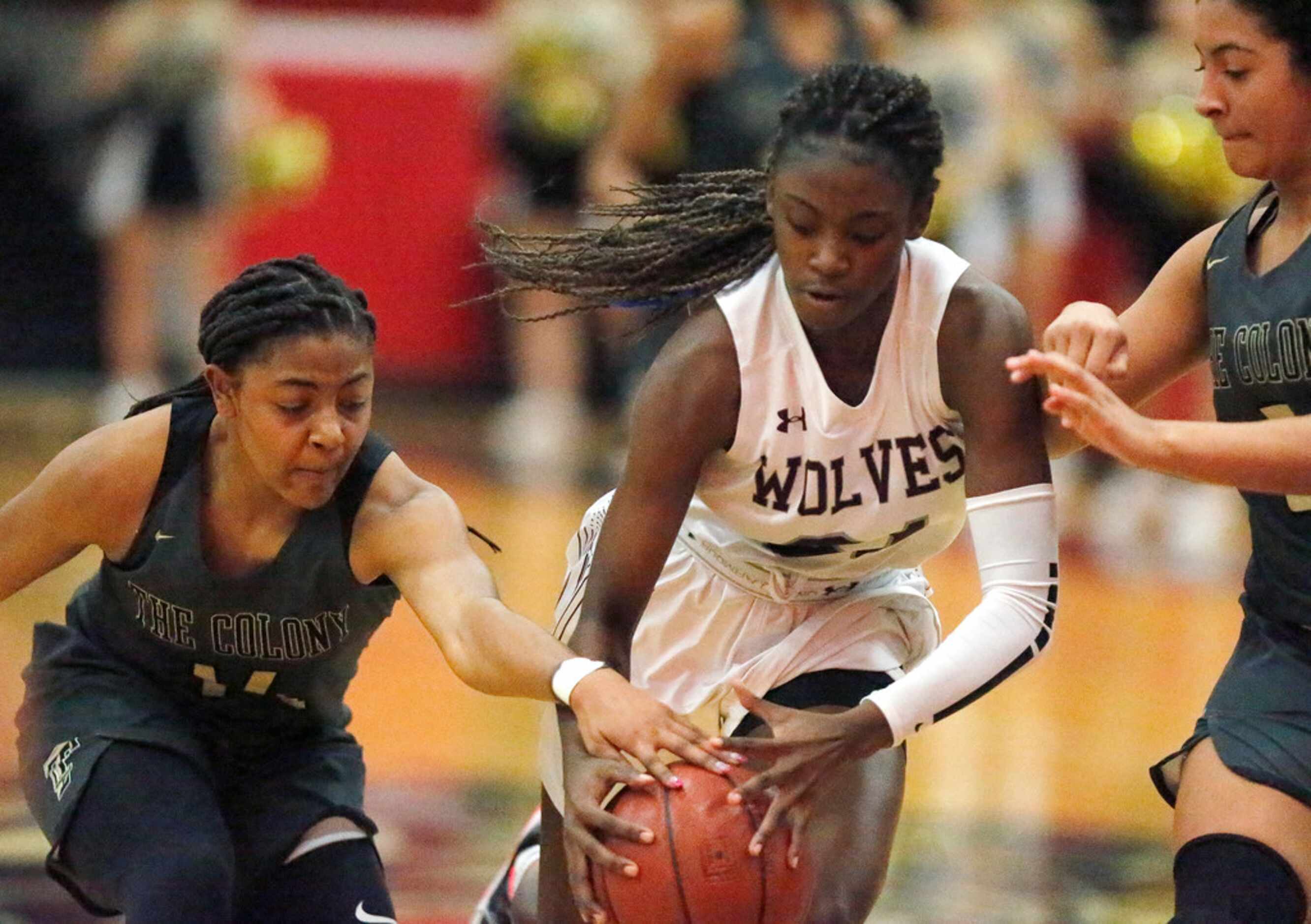 The Colony High School Tamia Jones (14) stops the dribble of Timberview High School guard...