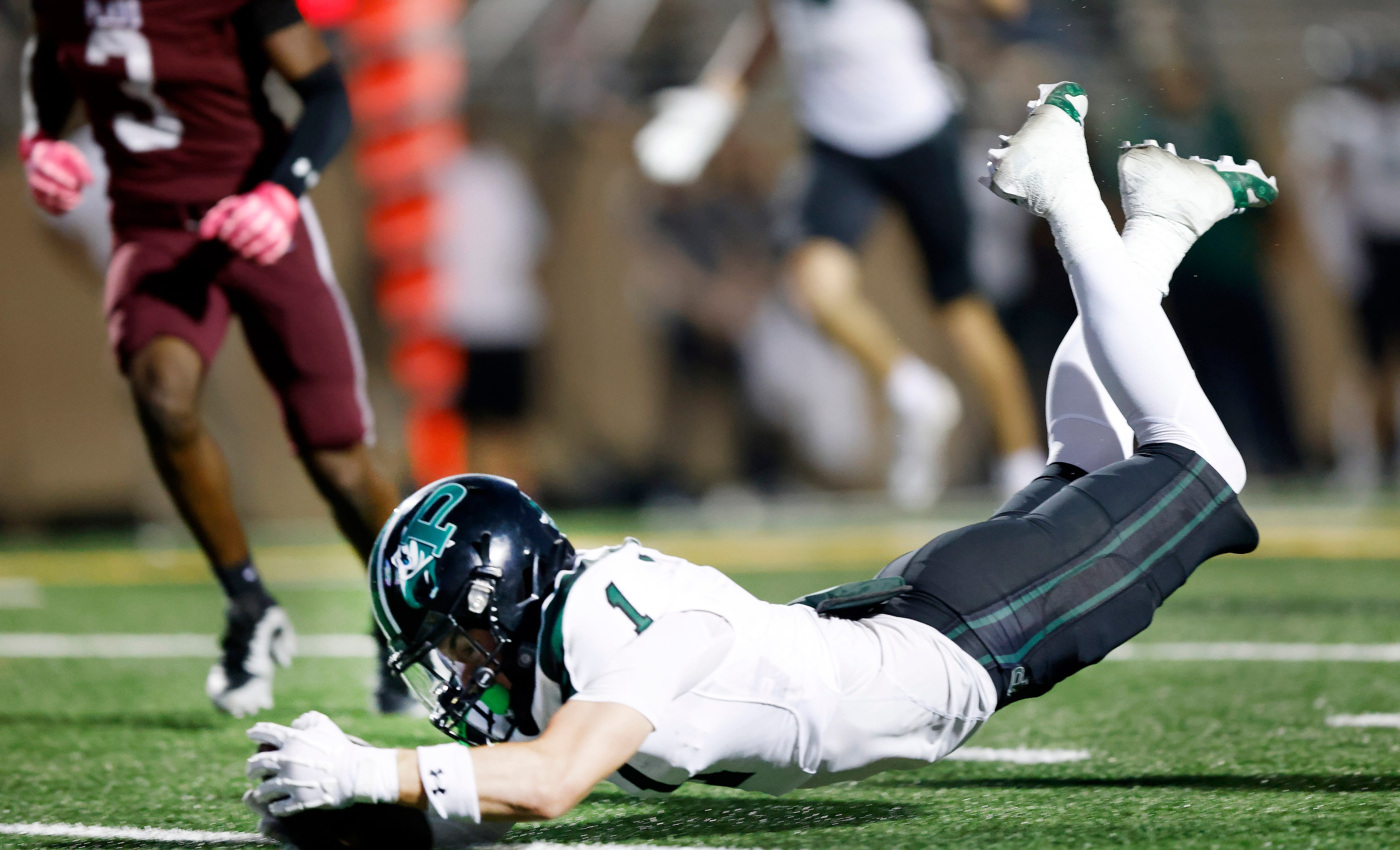 Prosper High’s Lathon Latiolais (1) dives across the goal line for a first half touchdown...