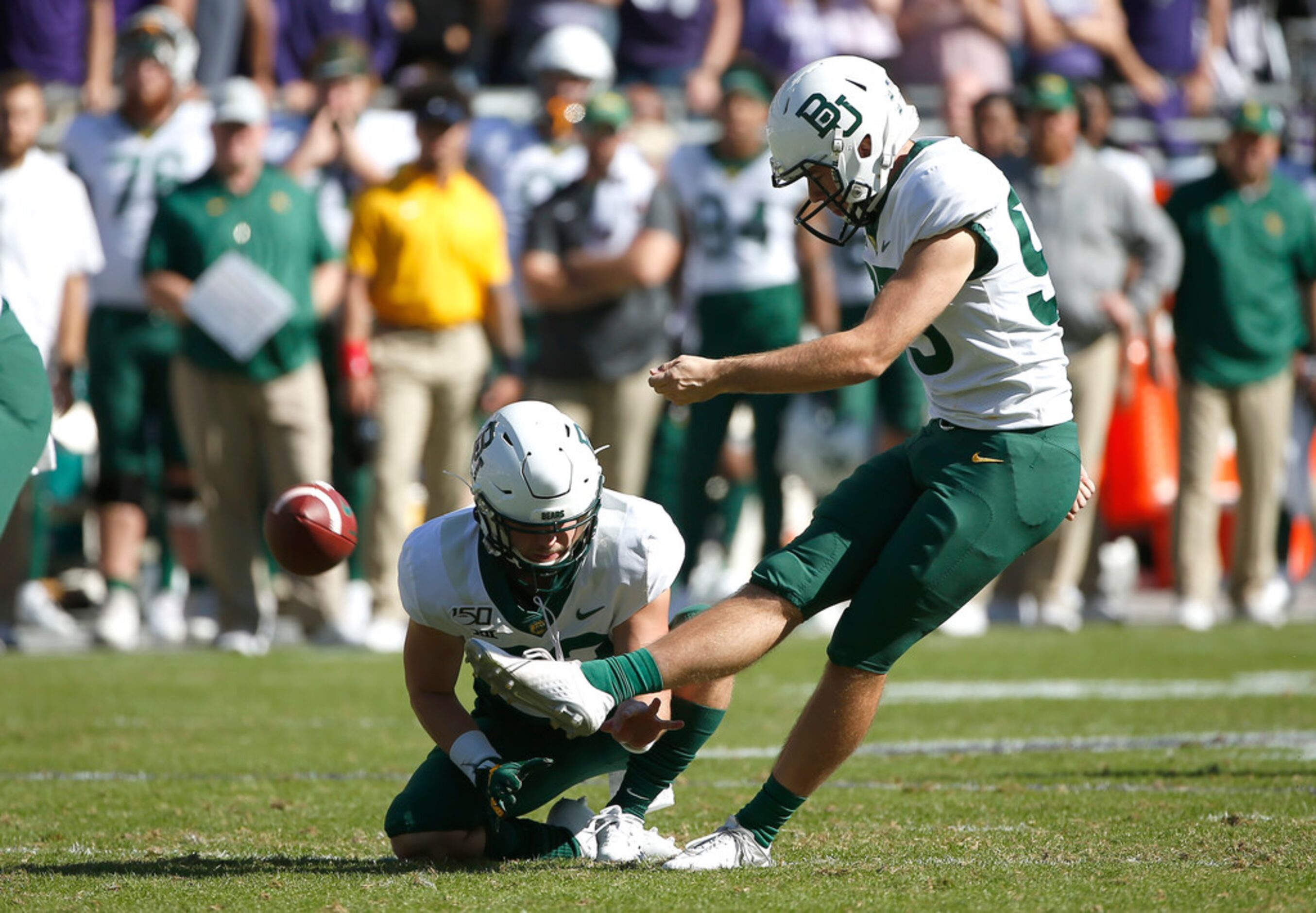 Baylor place kicker John Mayers (95) kicks a field goal as holder Skyler Wetzel (32) holds...