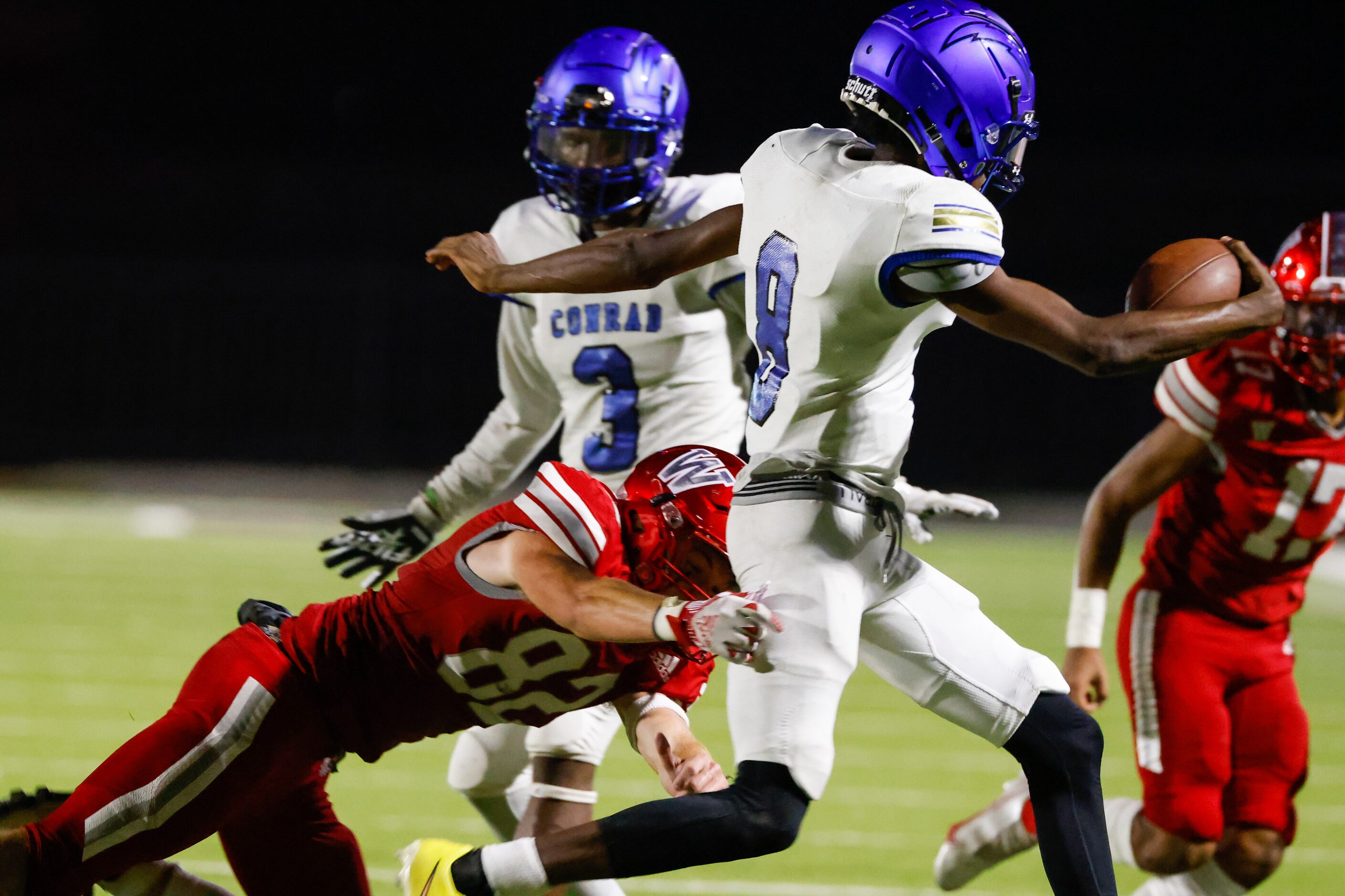 Conrad quarterback Ladavian Frost-Harris (8) runs toward the sidelines while being chased by...